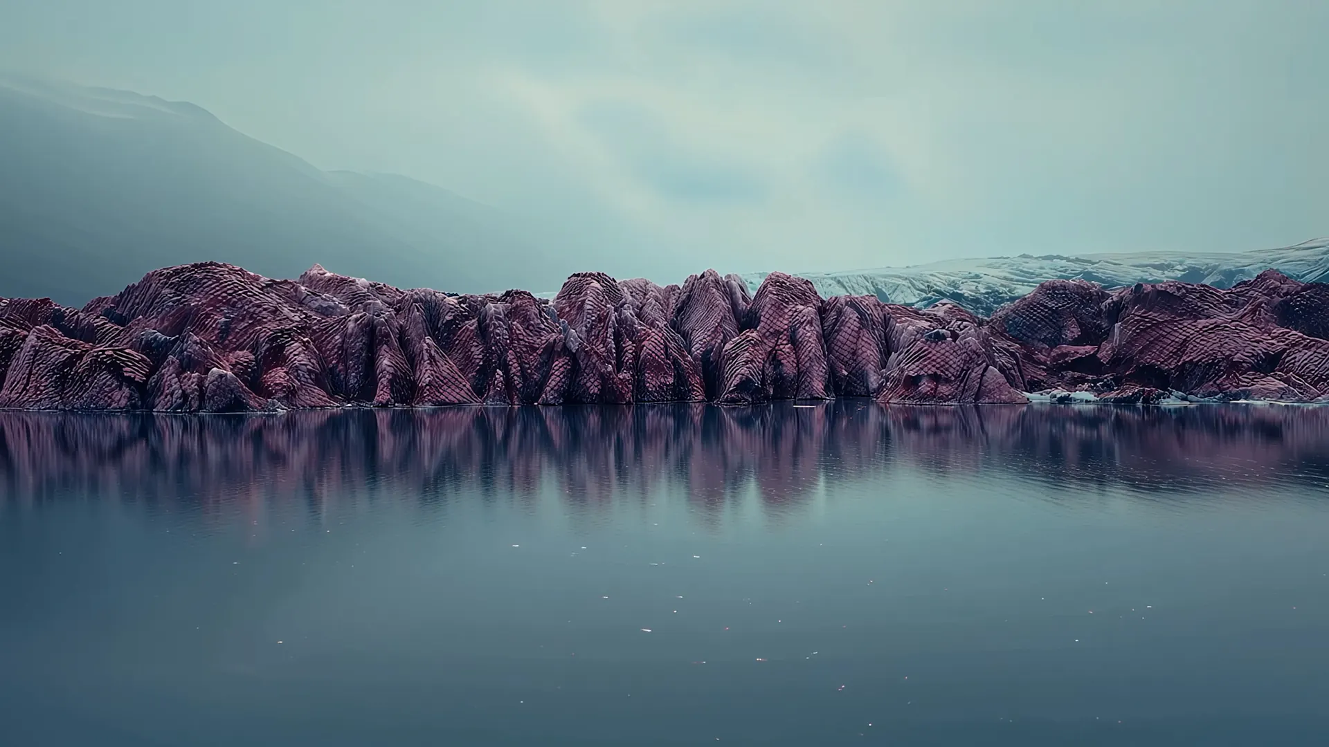 A scale-armored glacier ridge across calm water